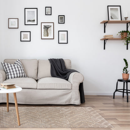 Geometric Tufted Rug in a neutral, scandinavian living room in front of a beige loveseat