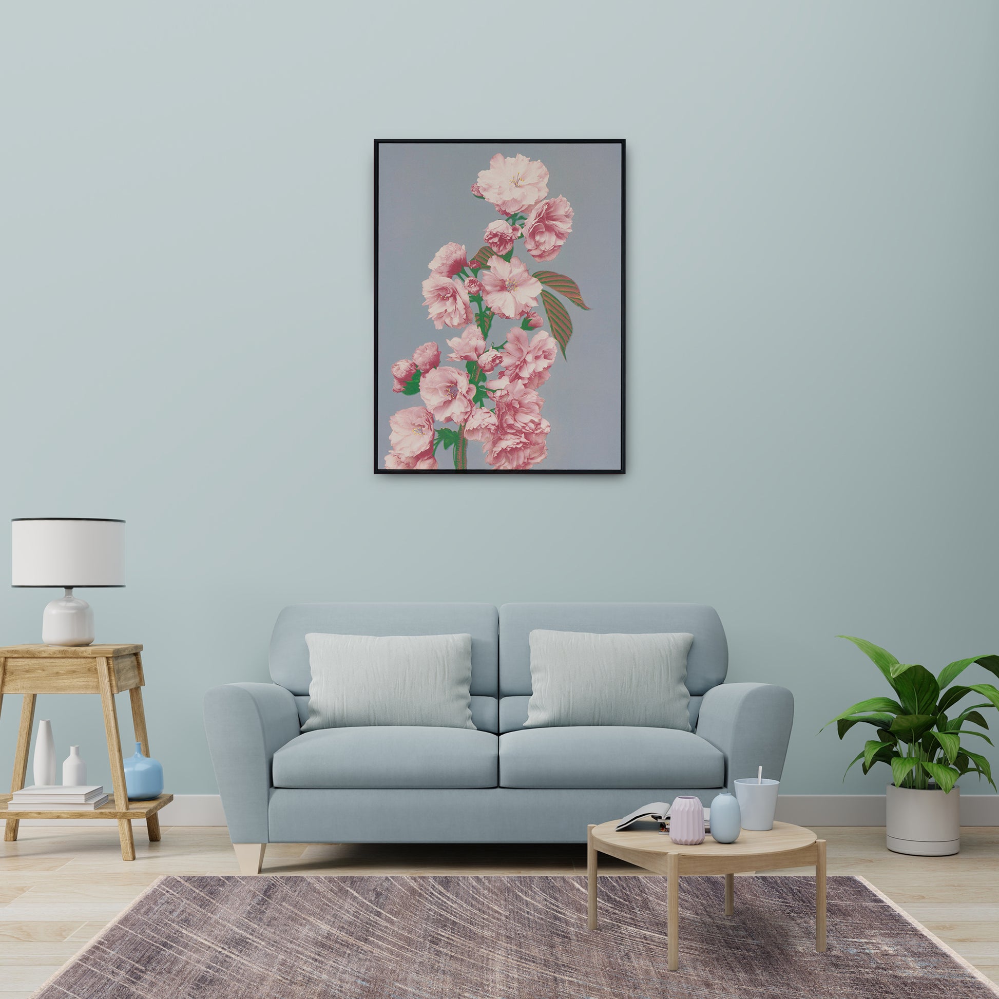 Modern living room featuring Mystic Grey Rug with distressed design on cool grey and earthy tones, wooden coffee table, side table, plant and large flower print on wall