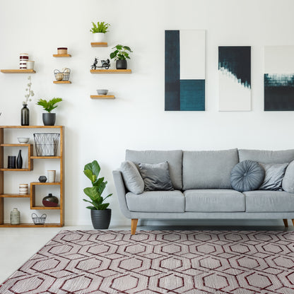 Modern living room with blue, grey accents, plants on the shelves, grey couch and Pera Trellis Rug